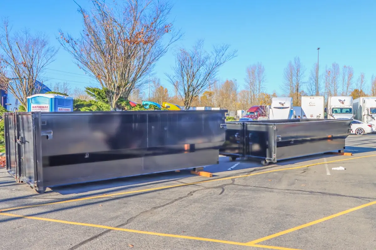 Professional dumpster rental service with roll-off container on residential driveway in Iowa Colony